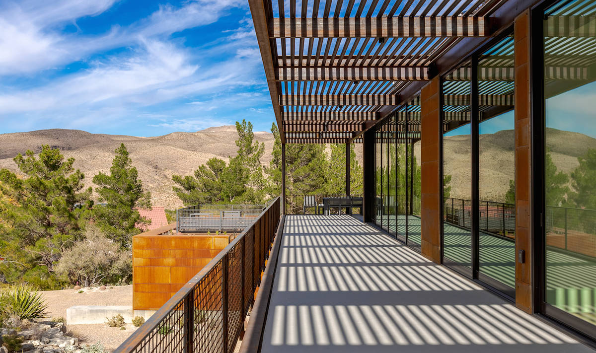 The expansive deck runs along the back of the home, offering views of the Spring Mountains. (Th ...