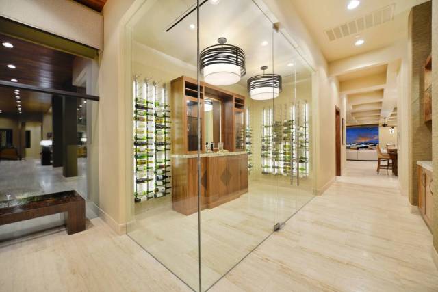 The luxury home has a lot of special spaces, including a wine cellar. The back of the home has ...