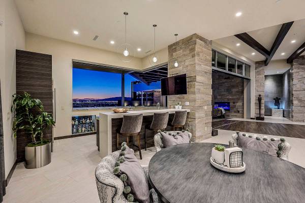 The kitchen bar extends to the pool area via a large window. Indoor/outdoor living spaces are i ...