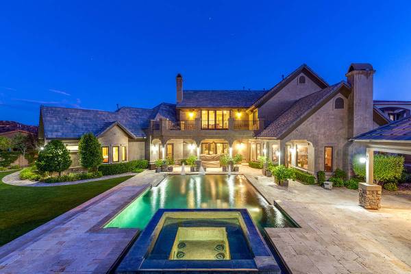 The backyard features an infinity-edge pool, spa, barbecue, multiple covered patio areas, an ou ...