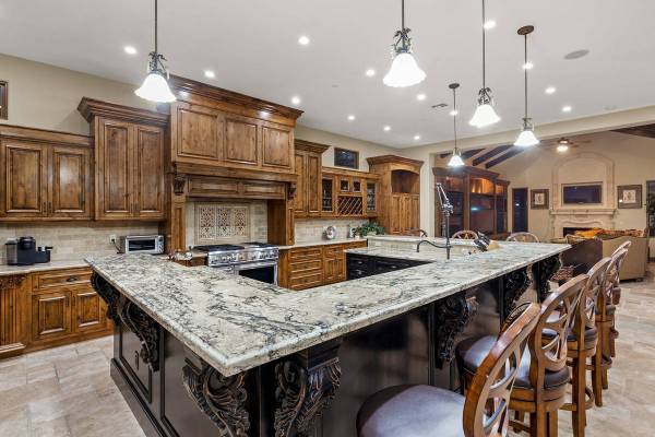 Downstairs features a massive chef’s kitchen complete the latest appliances and plenty of cab ...