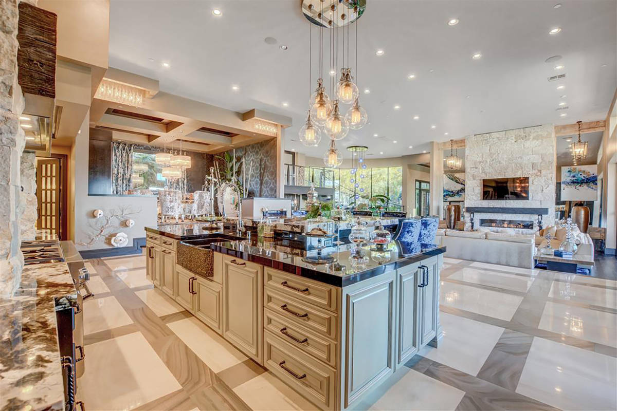 There’s a Nick Alain custom chandelier in the kitchen along with a Thermador stove and two Th ...