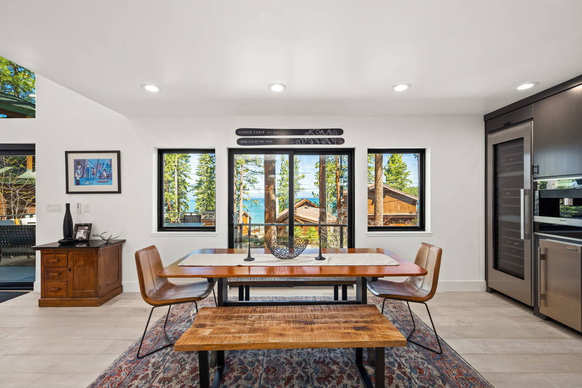 The dining room’s expansive windows and slider allow natural light to flood the space. The un ...