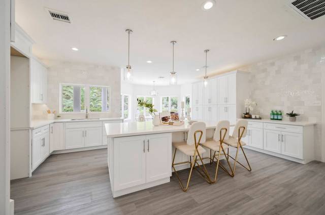 The gourmet kitchen features the latest appliances was recently remodeled. (LUXE Estates & Life ...