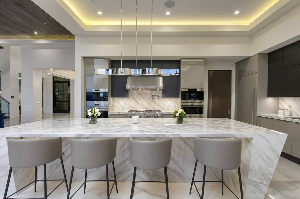 The kitchen features an island with seating. (Kristen Routh-Silberman)