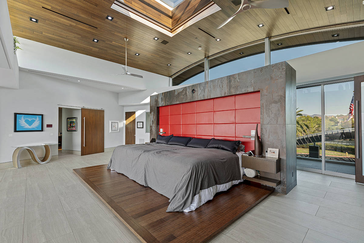 The master bedroom, which has direct access to one of the three garages, also features a retrac ...