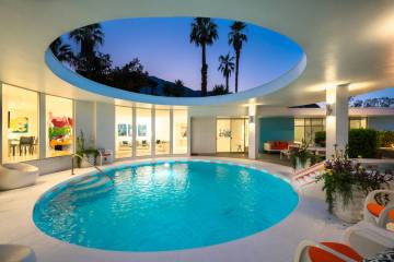 This 1963 Palm Springs home features a partially enclosed outdoor space, which is set under a s ...