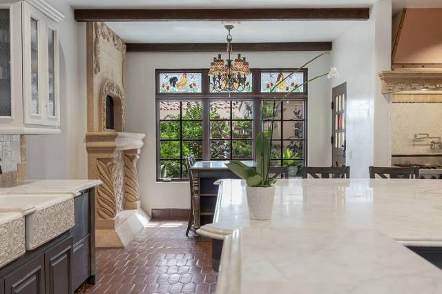 The kitchen features a floor-to-ceiling fireplace in the breakfast nook. (Ivan Sher Group)