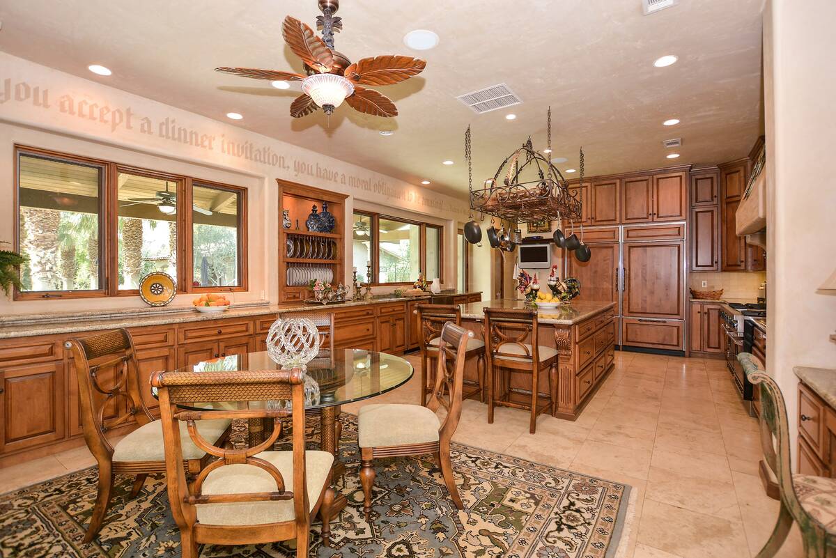 The kitchen features a large gathering island with a second sink. (BHHS)