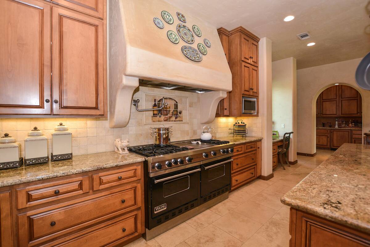 Just beyond the great room is an oversized kitchen with custom wood cabinets. (BHHS)