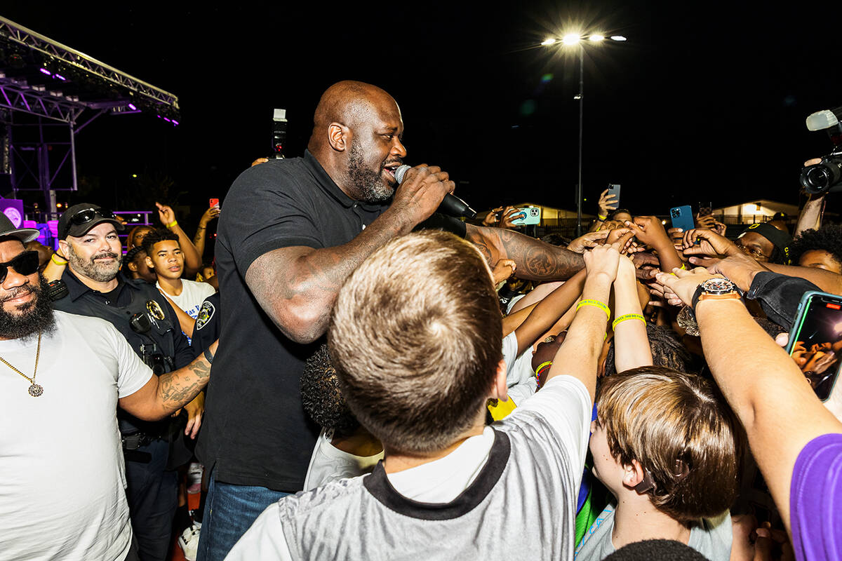 Shaquille O’Neal and local young basketball players celebrate after 13-year-old Alex Smith si ...