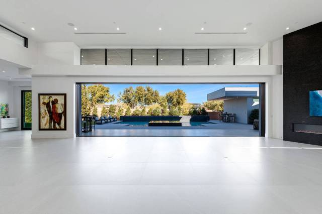 Located in Indigo at The Ridges, 58 Crested Cloud Way integrates oversized gallery corridors to ...