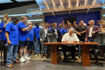 Gov. Steve Sisolak signs Senate Bill 430 at the IBEW Union Hall on June 10, 2021. (Nevada State ...
