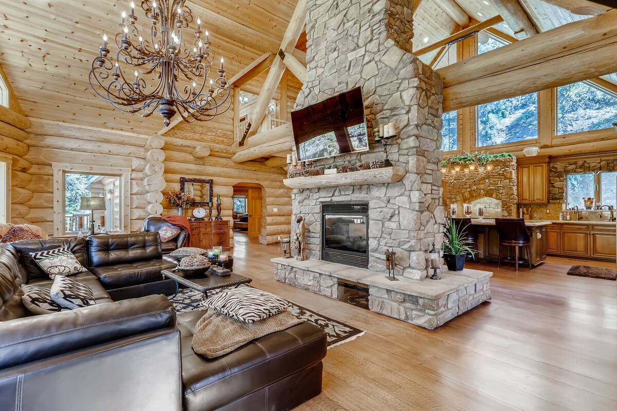 The rustic retreat features a stone foreplace and a A hand-finished sizeable Frank Ramond-desi ...