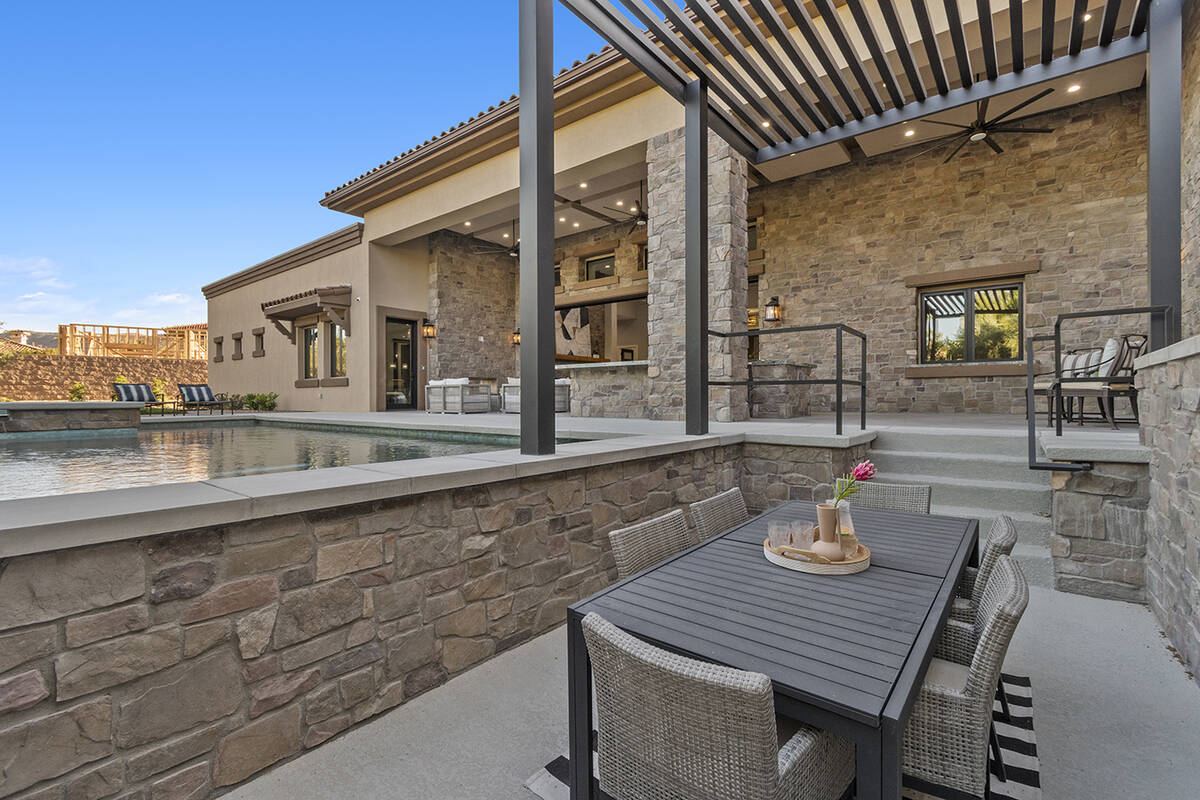 The outdoor dining area is by the pool. (Darin Marques Group)