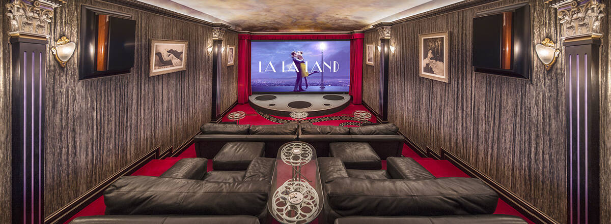 The 10-seat theater features India silk walls, custom ceiling on spring system and 16-foot scre ...