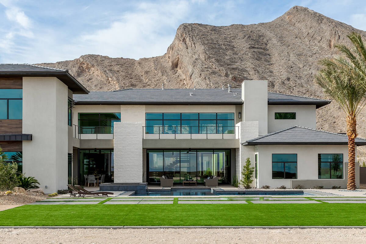 The Lone Mountain house measures 8,900 square feet with seven bedrooms, nine baths and a six-ca ...
