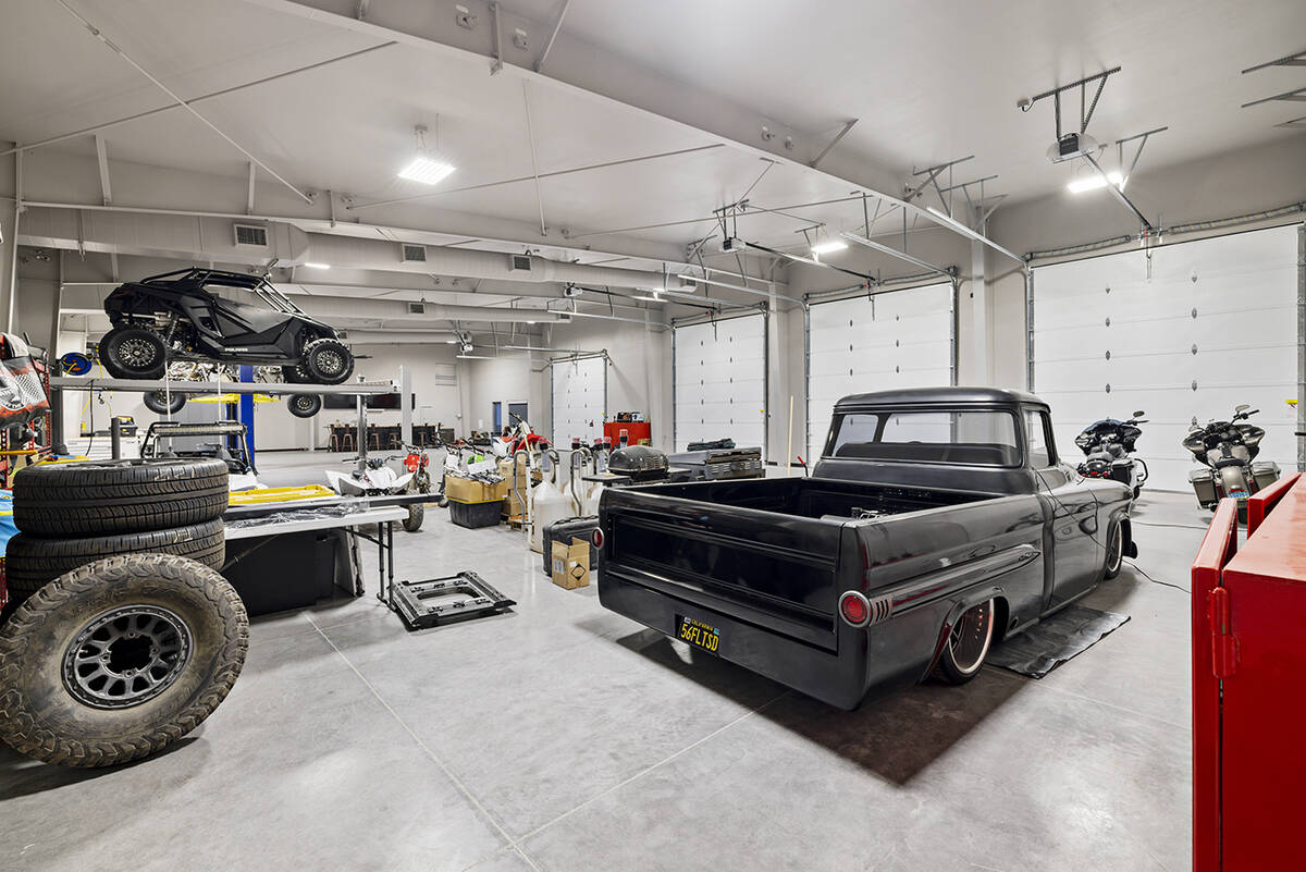 On one side of the reimagined property is a 5,000-square-foot four-bay garage and workshop that ...