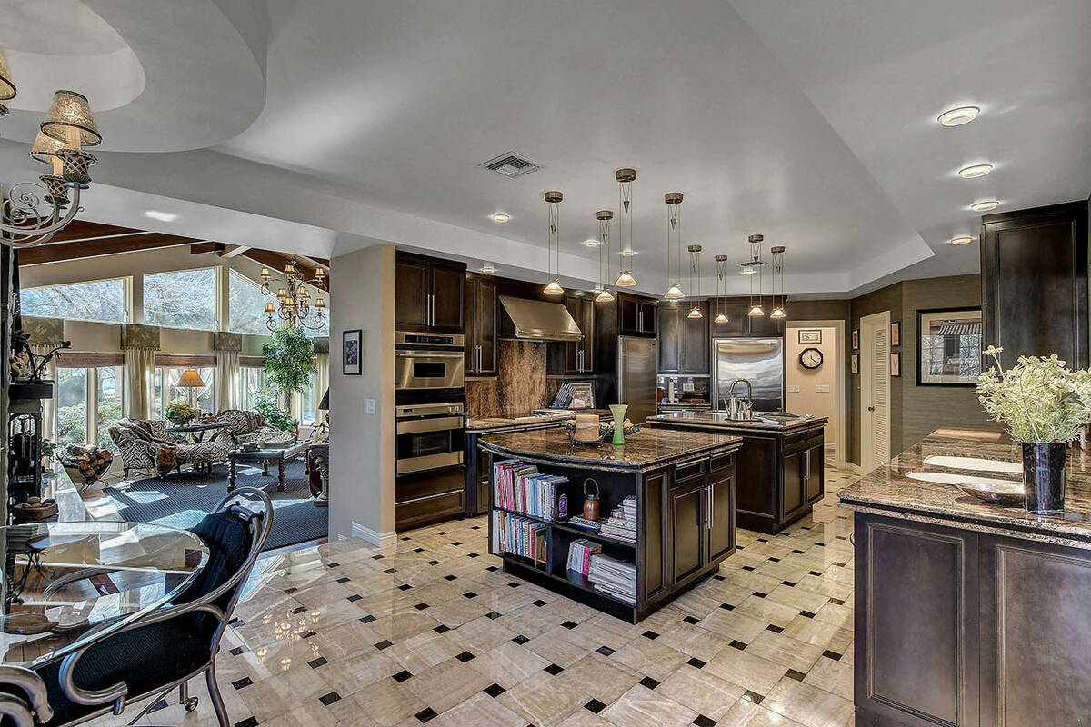The fully renovated kitchen showcases black cabinetry. (Desert Sun Realty)