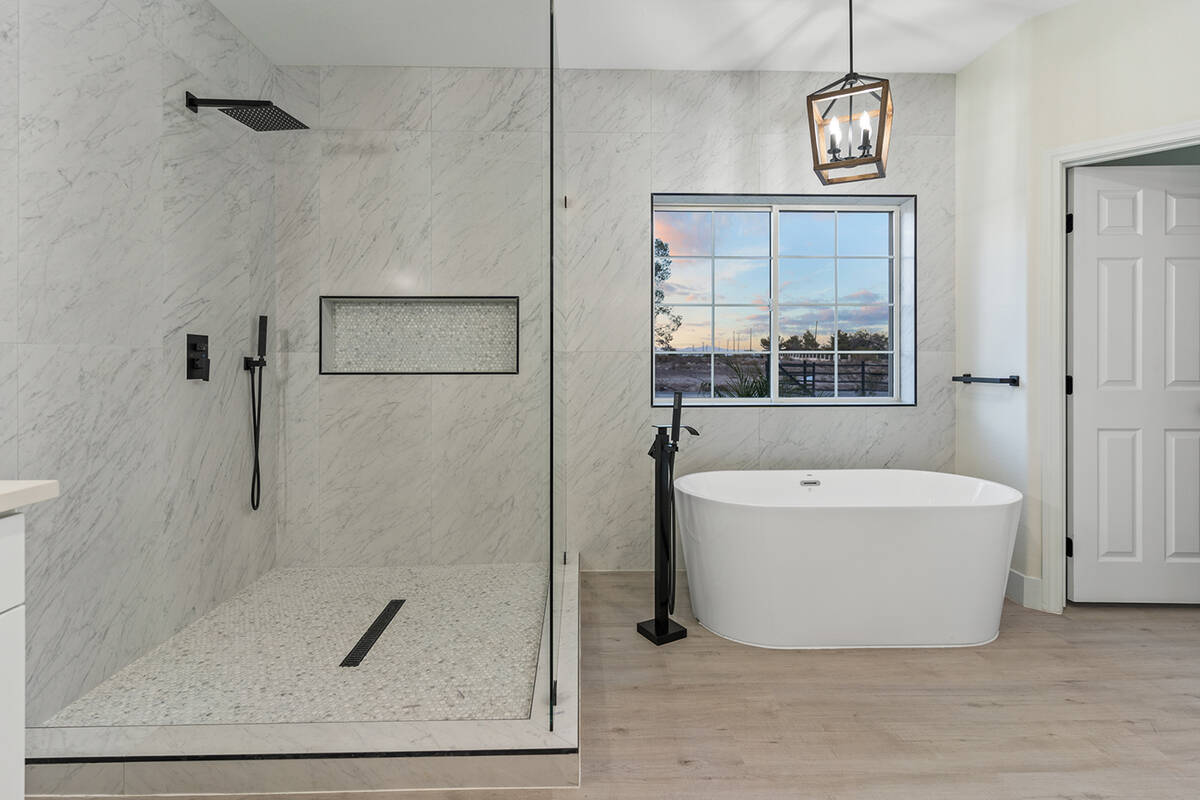 Master bath features a soaking tub and an oversized shower. (Sotheby’s International Realty)