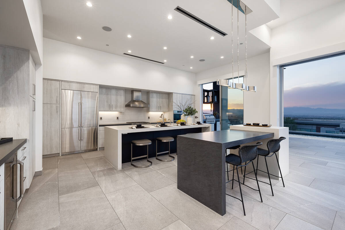 In the spacious kitchen there is a Kelly Wearstler Avant linear pendant over the island. The fr ...