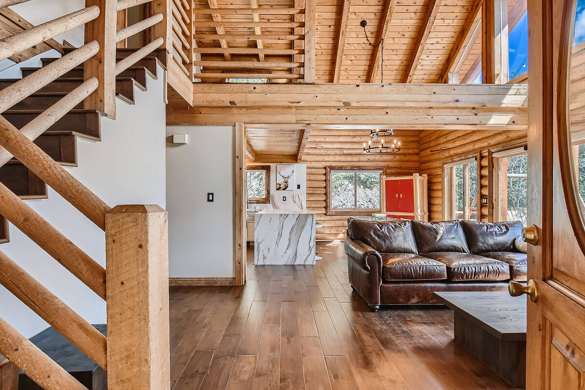 The cabin has been remodeled with rich hardwood flooring that replaced outdated carpeting. (Mt. ...