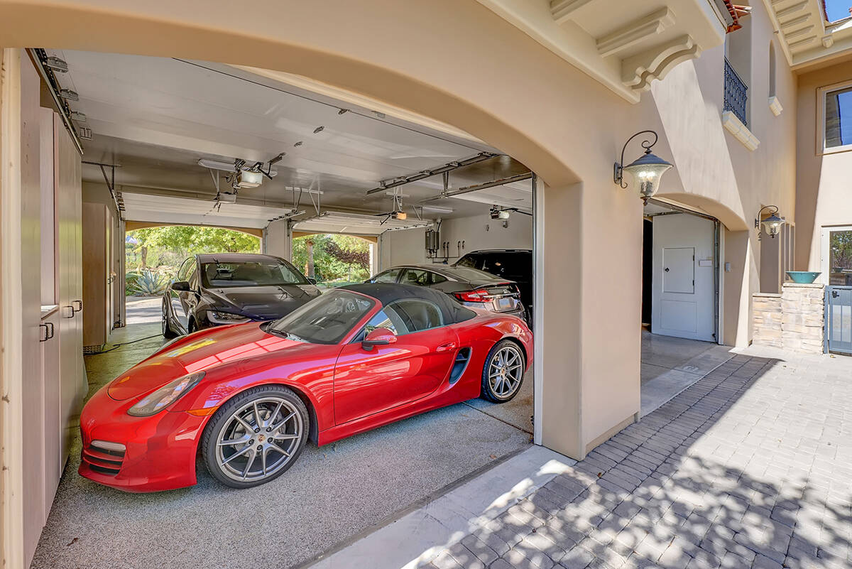The homeowners can drive under the home to enter the drive-through garage with doors on each si ...