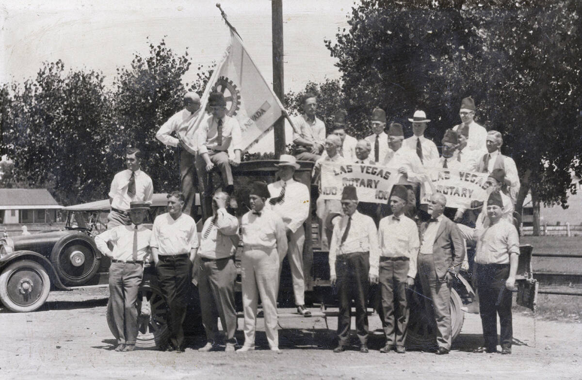 A photo from the 1920s shows Las Vegas Rotary Club member C. P. Squires holding a banner on the ...