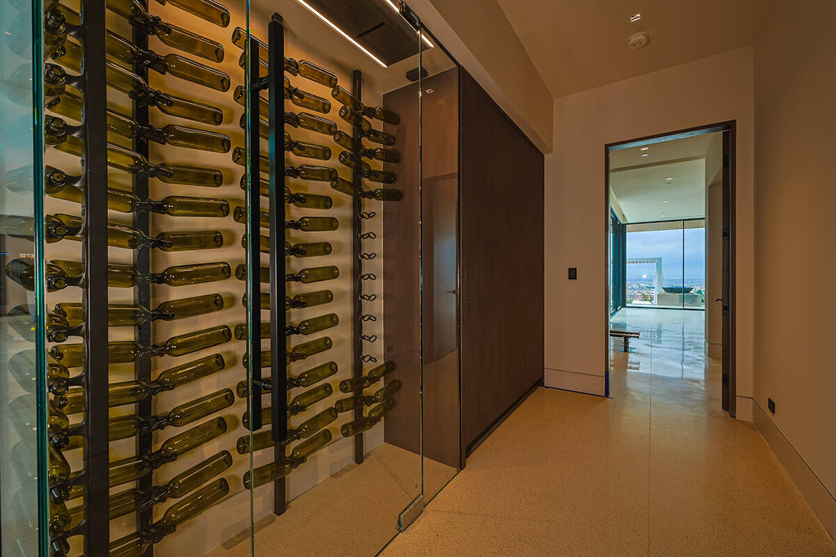 There are two wine walls behind the living room's 12-foot horizontal modern fireplace. (Luxus D ...