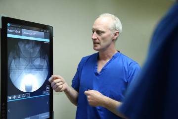 Dr. Erik Kubiak, UMC’s chief of orthopedic surgery, demonstrates the OrthoGrid artificial int ...