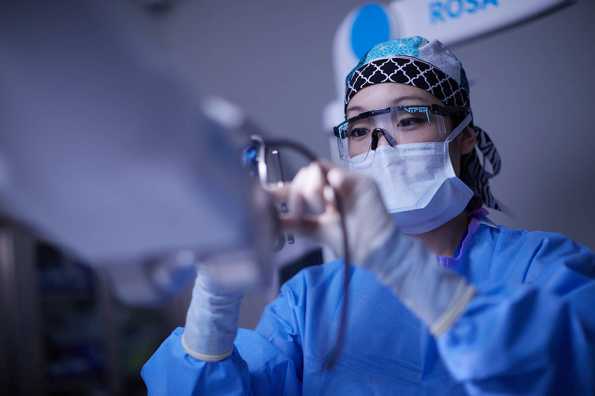 A UMC team member prepares the ROSA robotic knee replacement system in an operating room at UMC ...