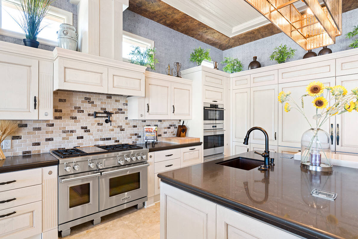 The kitchen includes an espresso maker, steam oven, warming drawer, three ovens and range hood. ...
