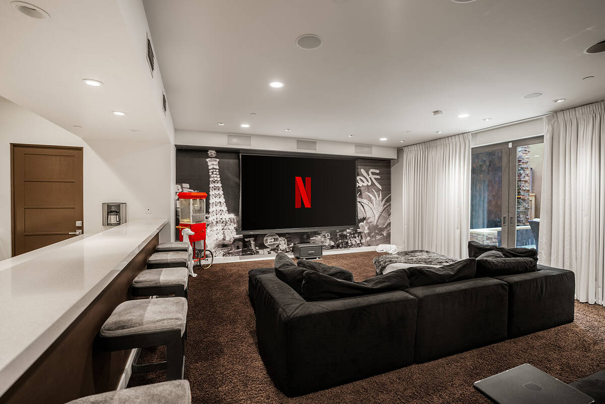 The home theater is on the lower level of the home. It has a full bar and a sophisticated glass ...