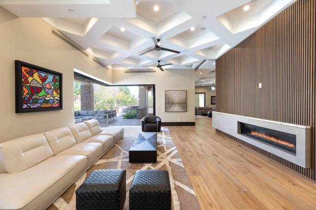 The living room features a modern horizontal fireplace. (BHHS)