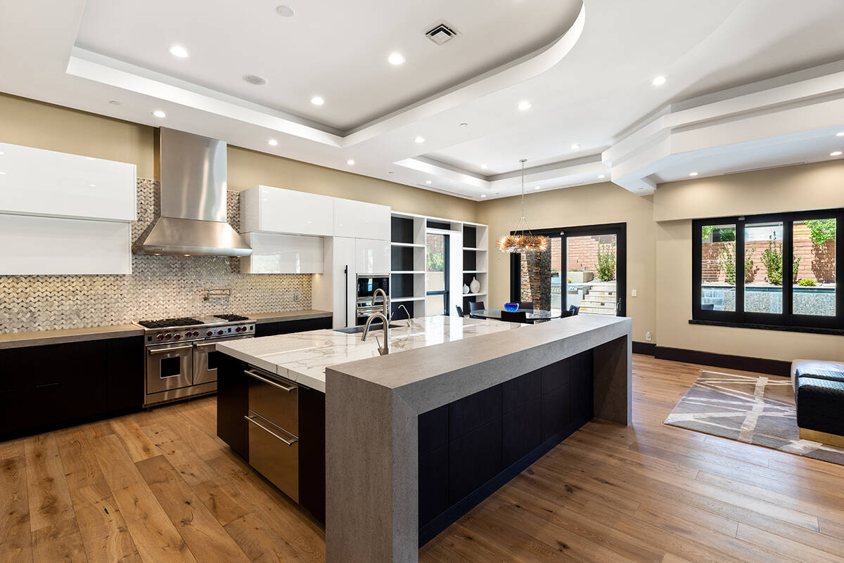 The kitchen features a large center island and bar. (BHHS)