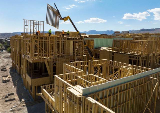 Last year construction workers help build a new Summerlin neighborhood. Las Vegas-based Home Bu ...