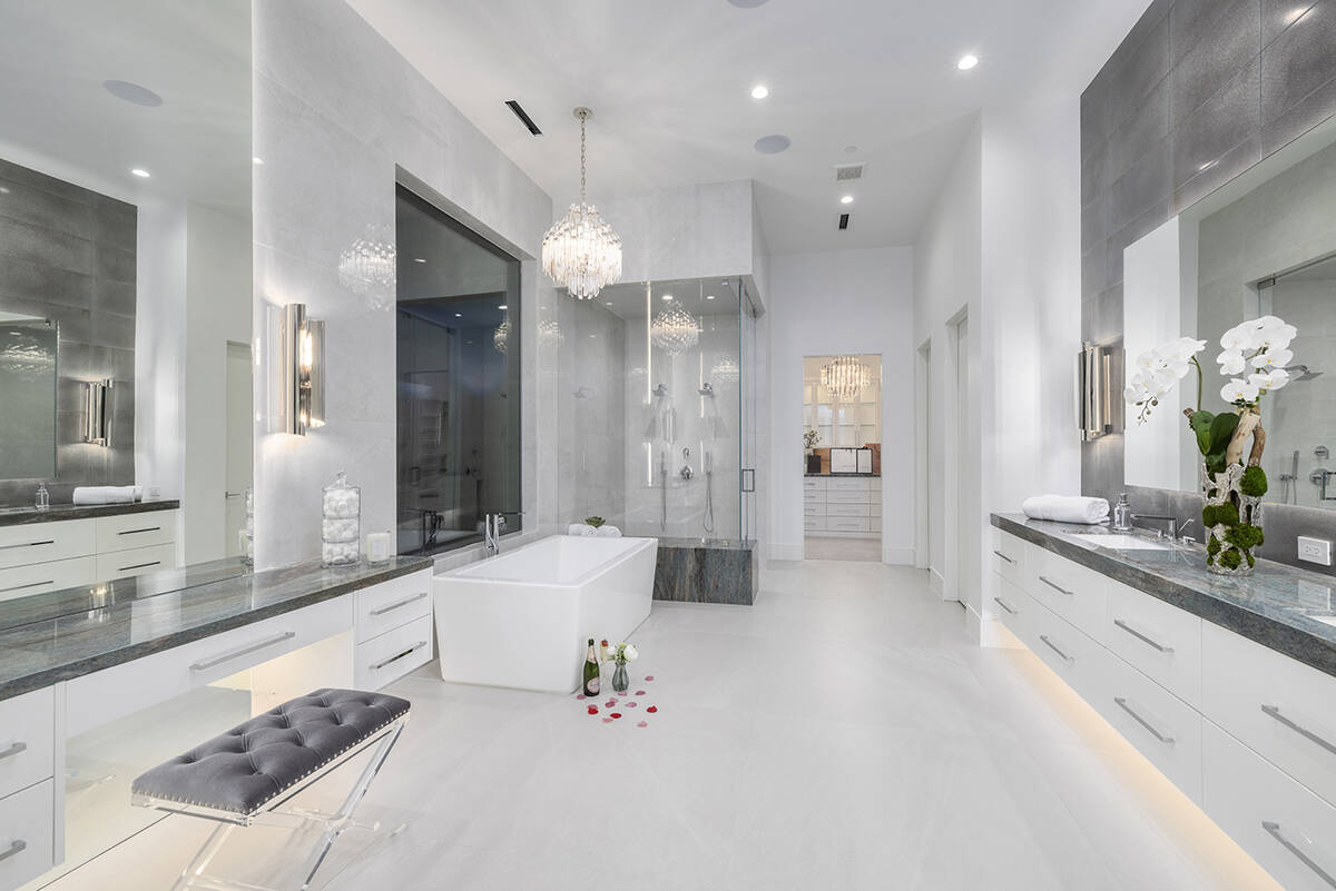 The master bath features a large soaking tub. The home has four bedrooms, 5½ baths and a four- ...