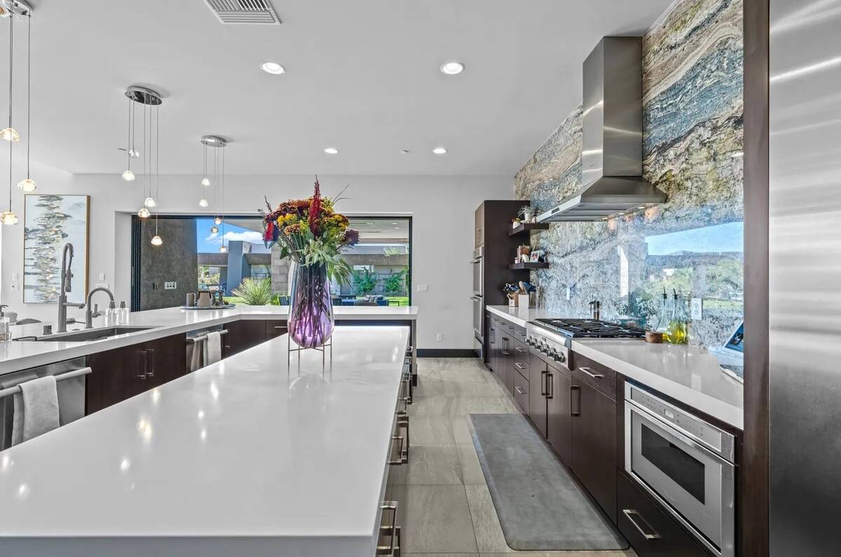 The kitchen also features top-of-the-line chef appliances and butler pantry with a wine bar, we ...