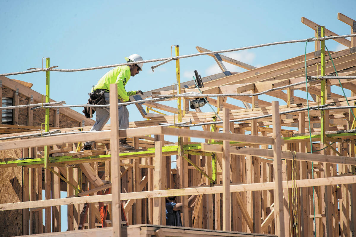 A construction worker helps build a new home in North Las Vegas. A recent report shows new home ...