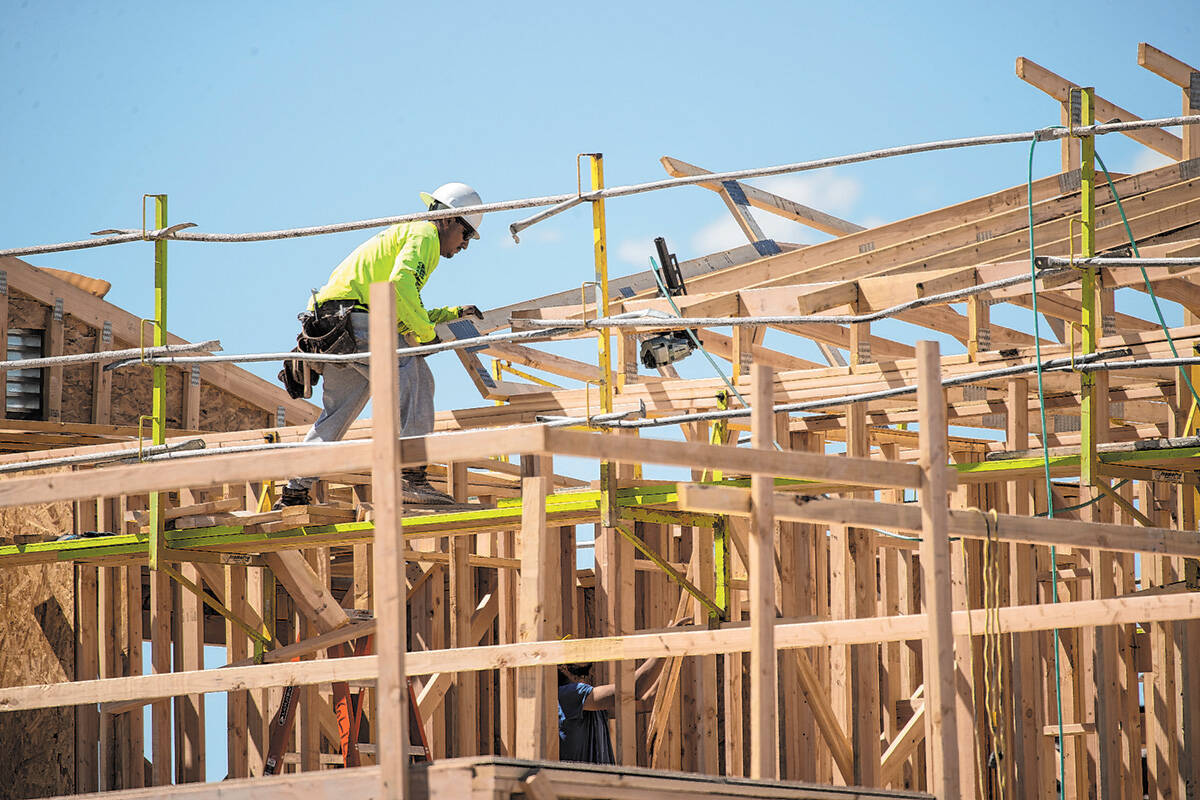 A construction worker helps build a new home in North Las Vegas. Homebuilders reported a 22 per ...