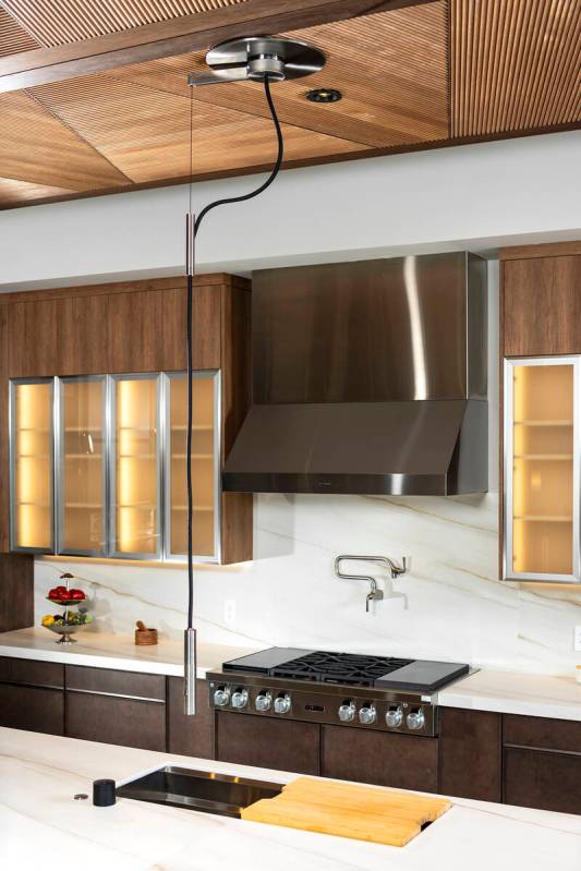 A highlight in the kitchen is the Kohler plumbing fixture, which drops from the ceiling. (Levi ...