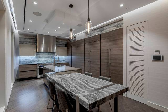 The kitchen in the Waldorf Astoria penthouse features a backsplash by artist Alex Turco, Miele ...