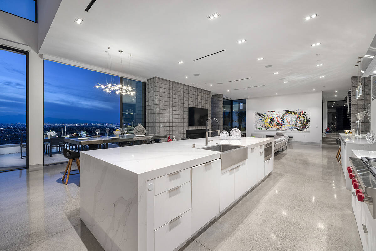This MacDonald Highlands mansion that sold in May features a modern kitchen with a large centra ...