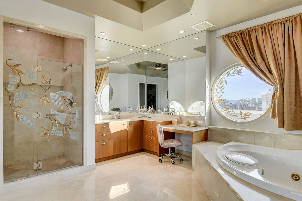 The primary suite has his-and-her baths with her bath being the largest one and featuring a soa ...