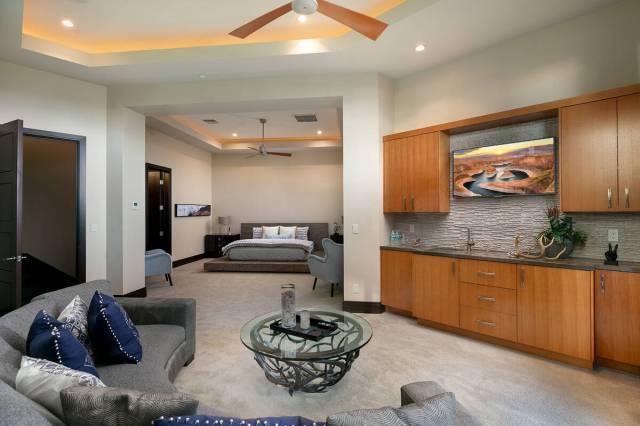 The main-level primary suite includes a separate sitting room and a large walk-in two-story clo ...