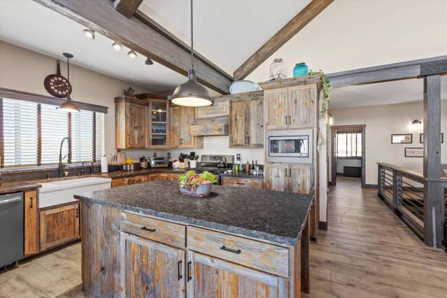 The kitchen features a wood-encased range hood and porcelain farm sink. (Mt. Charleston Realty ...