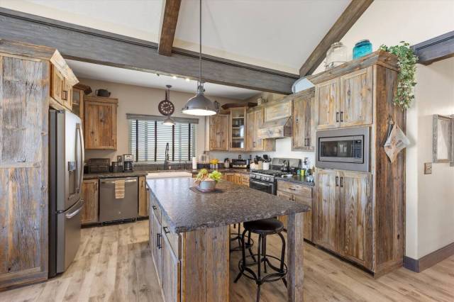 The contemporary kitchen blends austere elements with luxe finishes. Reclaimed barn wood custom ...