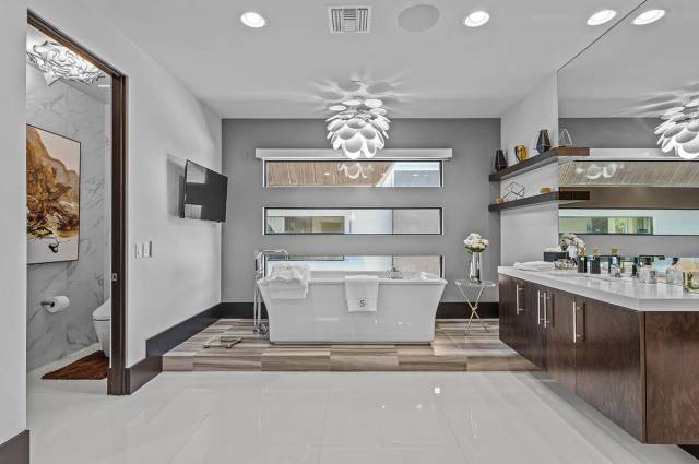 The 7,249-square-foot two-story home has eight baths, including this master bath. (Real Broker LLC)