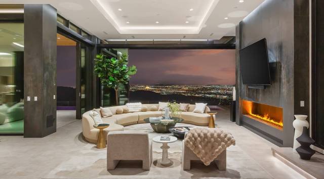 The two-story home that measures 10,459 square feet has six bedrooms, eight baths and a six-car ...