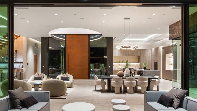 Inside, it’s pure luxury with stone floors, open-concept living, a glass wine cellar and a sl ...